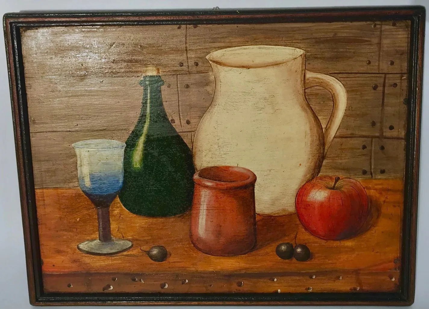 Still life of a glass, pitcher, bottle, apple and capulis on table